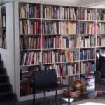 Custom built-in bookshelf with open shelving, painted finish, and wall-to-wall design in a living room.
