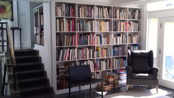 Custom built-in bookshelf with open shelving, painted finish, and wall-to-wall design in a living room.
