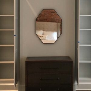 Built-in storage cabinetry with concealed cabinets and open shelving in a living room.