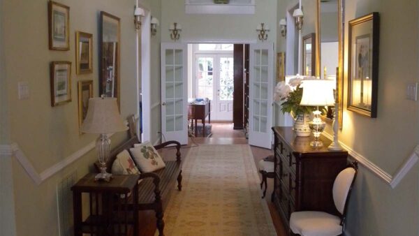 Classic built-in hallway cabinet with dark wood finish and concealed storage.