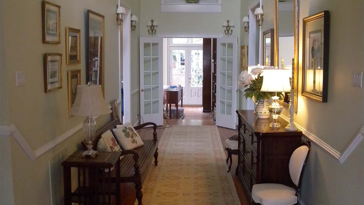 Classic built-in hallway cabinet with dark wood finish and concealed storage.