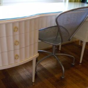 Handcrafted white built-in writing desk with integrated drawers and smooth work surface designed for a classic living room workspace.