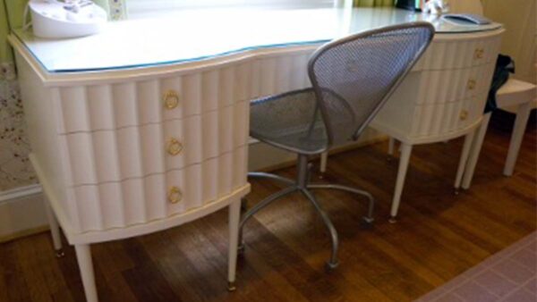 Handcrafted white built-in writing desk with integrated drawers and smooth work surface designed for a classic living room workspace.