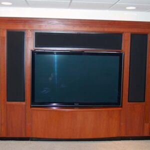 Handcrafted built-in entertainment center with integrated display and dark wood finish.