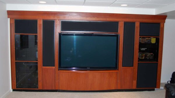 Handcrafted built-in entertainment center with integrated display and dark wood finish.