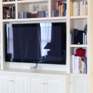 Handcrafted built-in entertainment center with open shelving and integrated display.