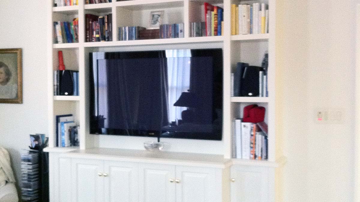 Handcrafted built-in entertainment center with open shelving and integrated display.