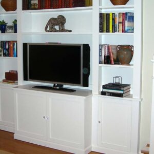 Handcrafted built-in entertainment center with open shelving and integrated media display.