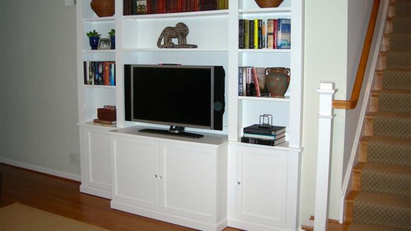 Handcrafted built-in entertainment center with open shelving and integrated media display.