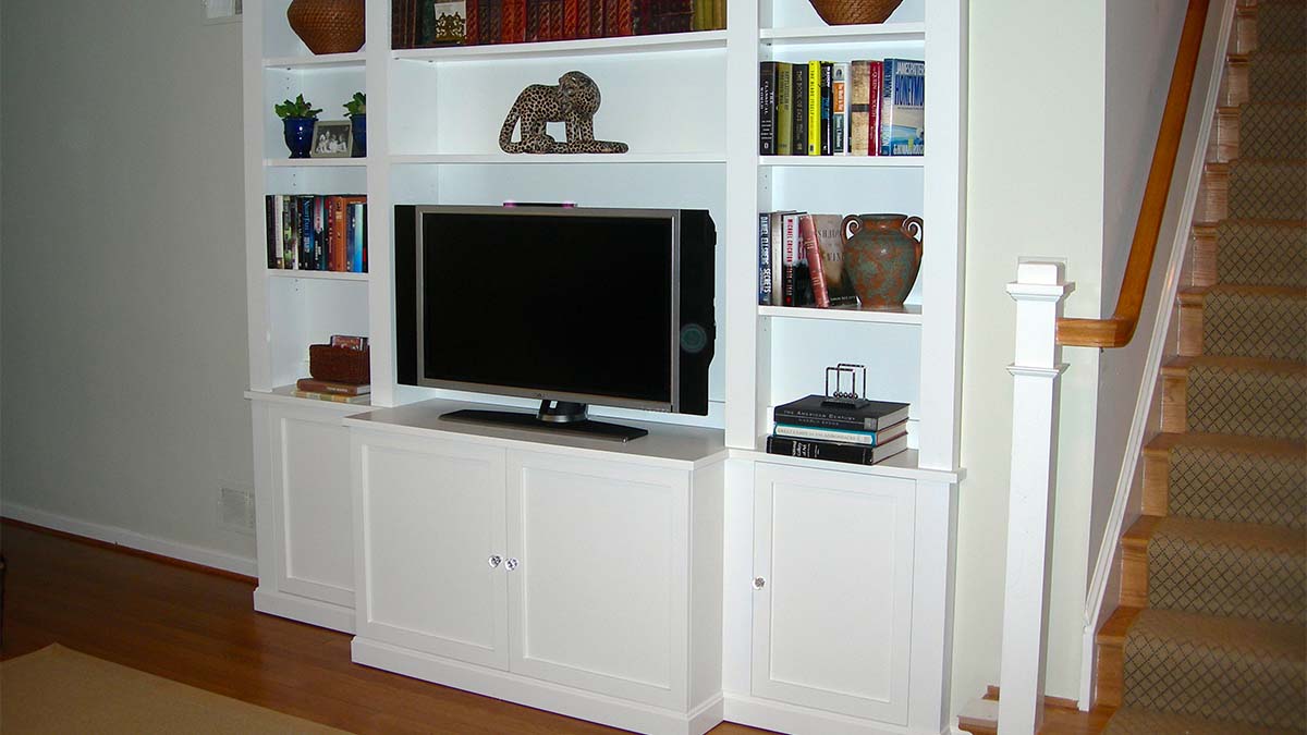 Handcrafted built-in entertainment center with open shelving and integrated media display.