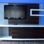 Handcrafted modern built-in entertainment center with high-contrast materials and integrated display.