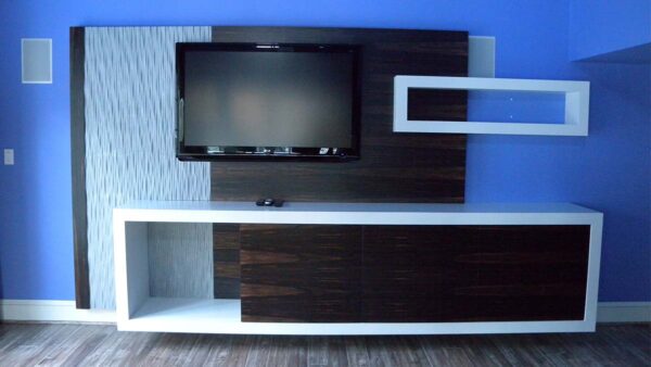 Handcrafted modern built-in entertainment center with high-contrast materials and integrated display.