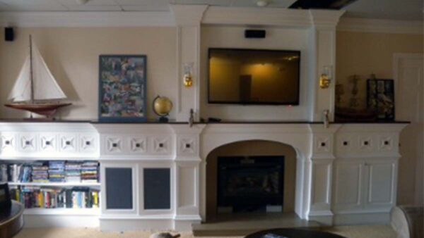 Handcrafted Entertainment Center with Integrated Library Handcrafted entertainment center with integrated library and fireplace surround.