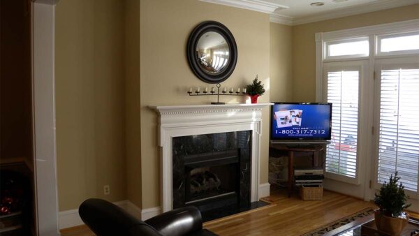 Handcrafted classic fireplace surround with painted architectural detailing.