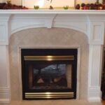 Handcrafted decorative fireplace surround with classic columns and arched mantel.