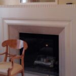 Handcrafted clean-line fireplace surround with painted finish and architectural proportions.