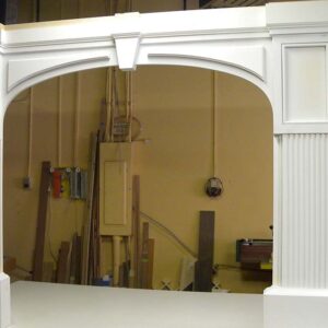 Classic architectural wood frame with arched opening and painted finish.
