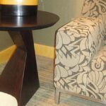 Handcrafted sculptural lamp stand with solid wood construction and dark finish.